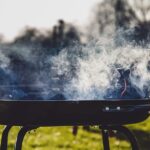 Smoke emanates from an outdoor grill